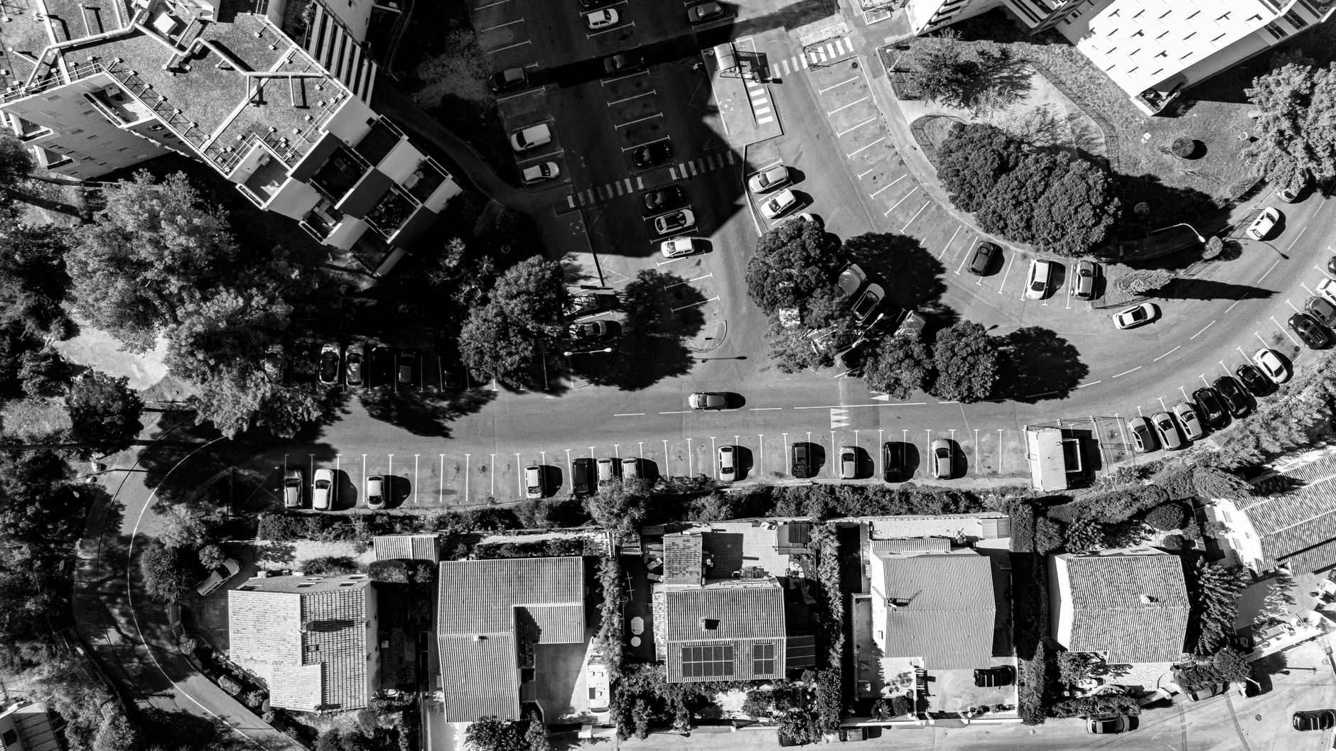 Black and white aerial view of residential buildings and parking in Marseille, France.